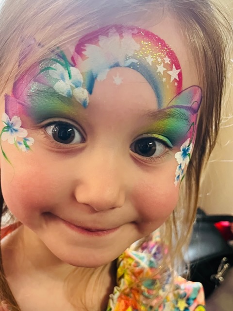girl with rainbow and fairy face paint in Shifnal